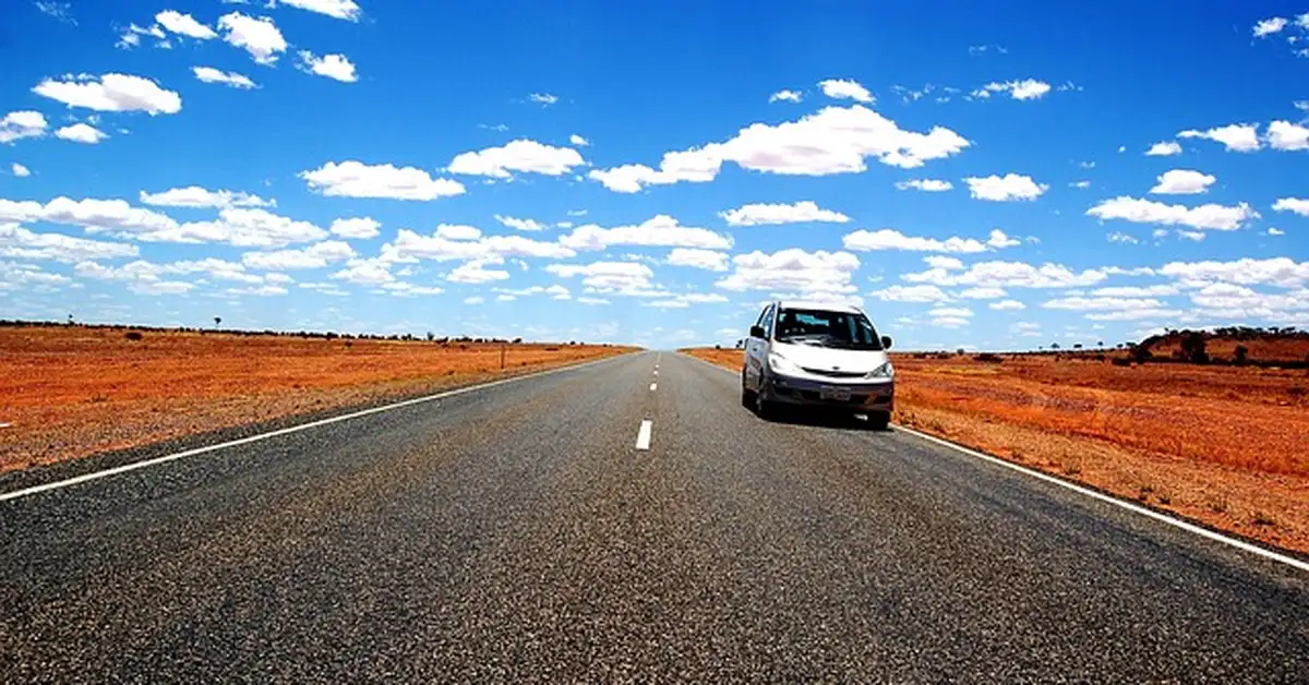 Rental car driving on a long empty highway