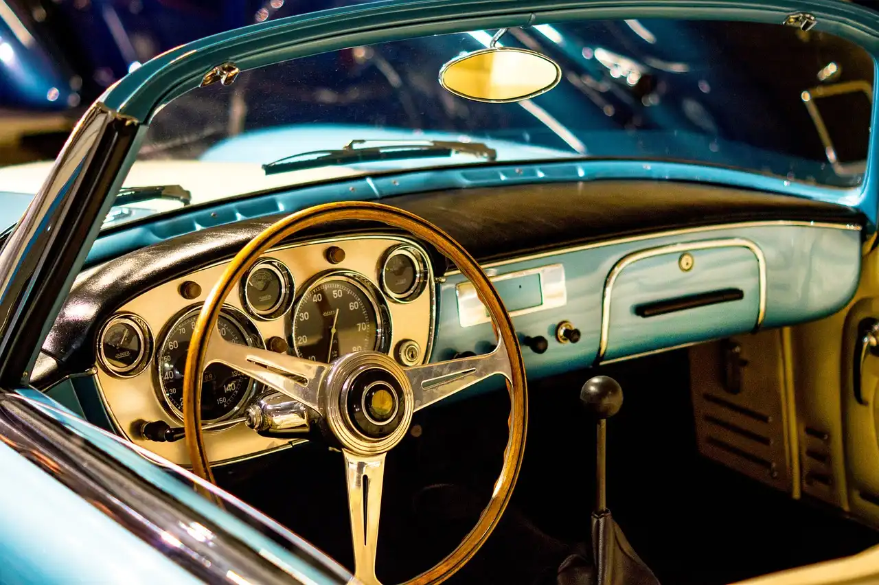 Dashboard cover fitted on a car dashboard in natural sunlight with vents and instrument cluster visible