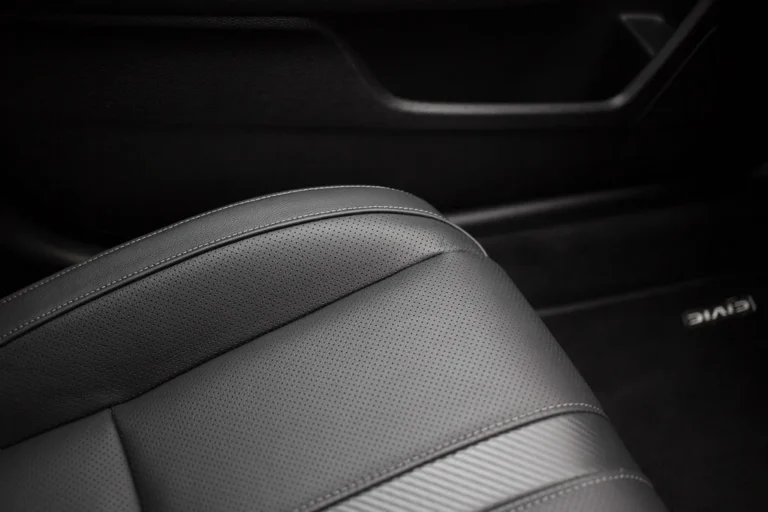 Leather cleaner wipes used for a quick touch-up on a car seat in natural light