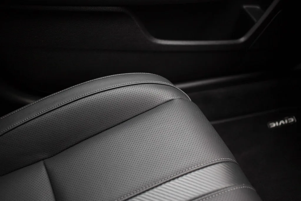Leather cleaner wipes used for a quick touch-up on a car seat in natural light