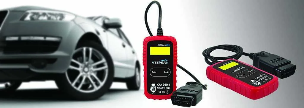 Hands plugging an OBD2 scanner into a car diagnostic port
