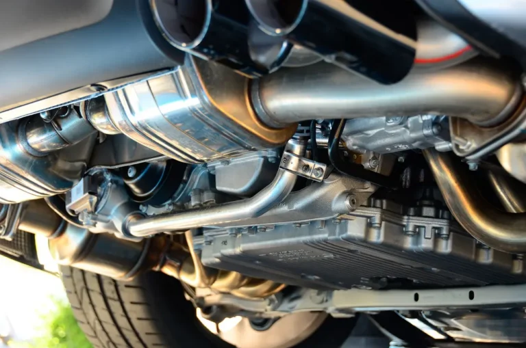 Turbo car on a lift with mechanic checking the oil cooler and front-mounted lines