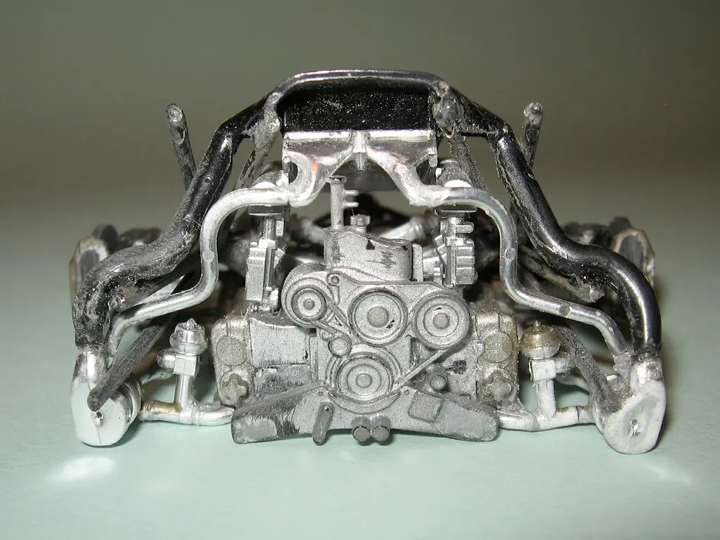 Close-up of a serpentine belt fitted around engine pulleys showing ribs and alignment