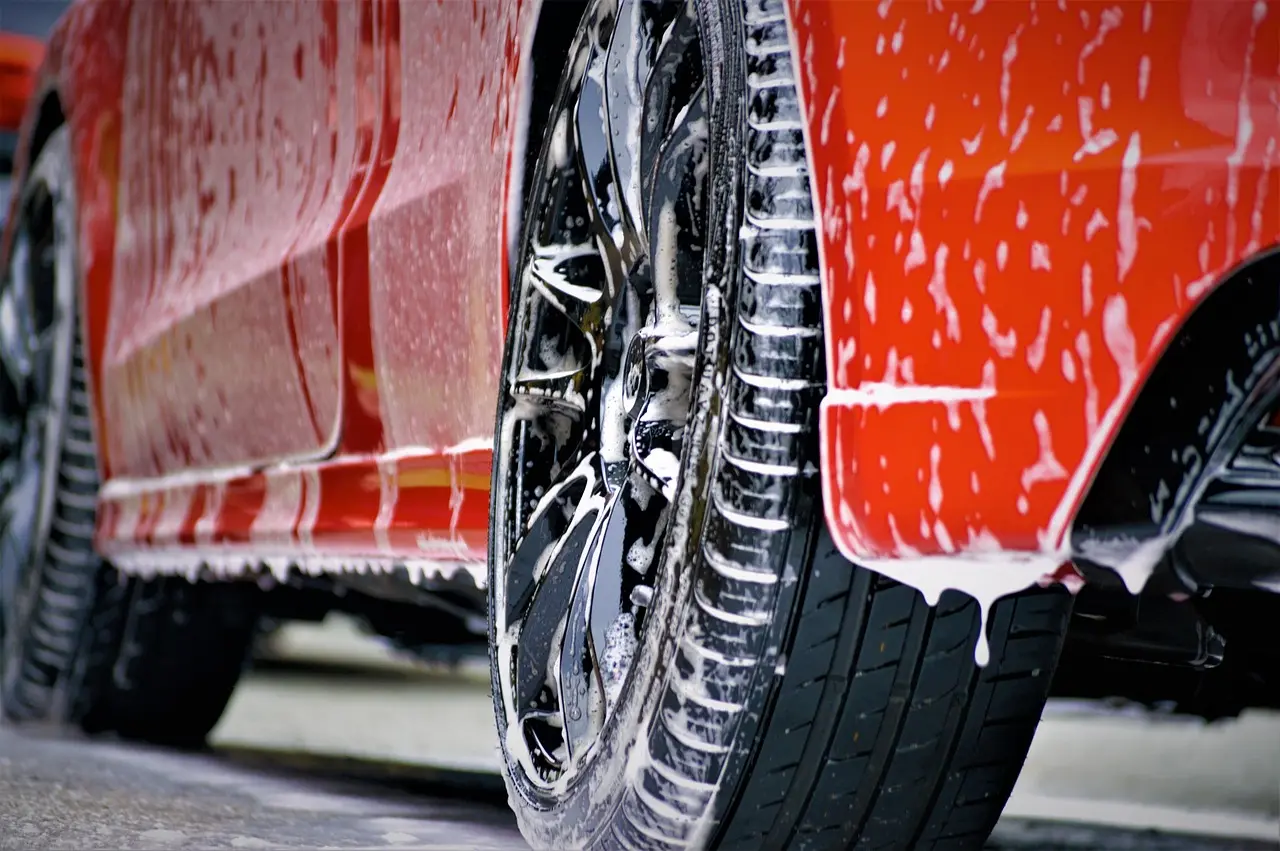 Daily driver being washed with microfiber mitt and buckets in a driveway