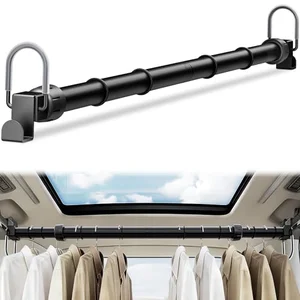 Adjustable car clothes hanger bar mounted across rear grab handles with clothes hanging