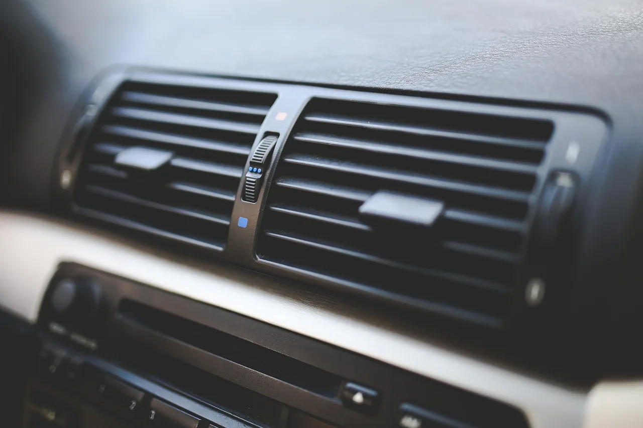 What is the difference between air conditioning and climate control in a car?