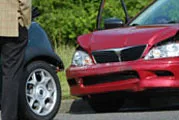 Hand comparing car insurance coverage costs with calculator, car key, and bills on a table