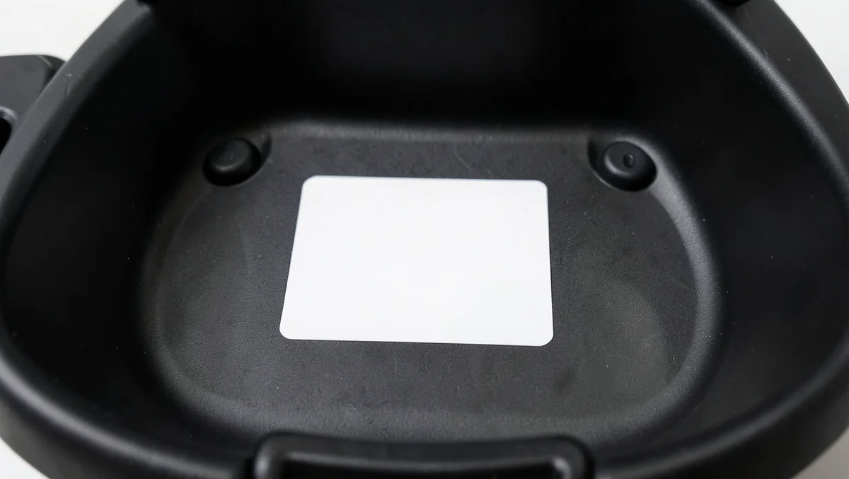 Underside of a convertible car seat shell showing where the expiration date label is placed