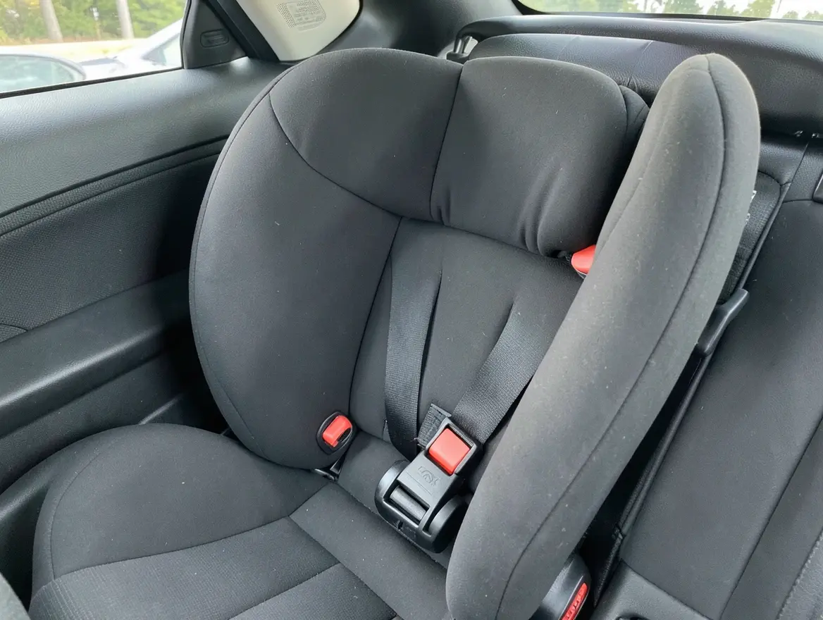 Close-up of a convertible child car seat with LATCH connectors properly installed in a car back seat