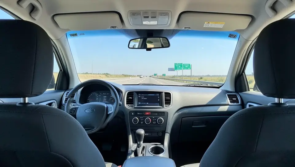 View from inside a car showing the open road and horizon through the windshield
