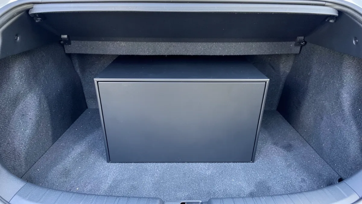 Subwoofer enclosure box installed in a car trunk