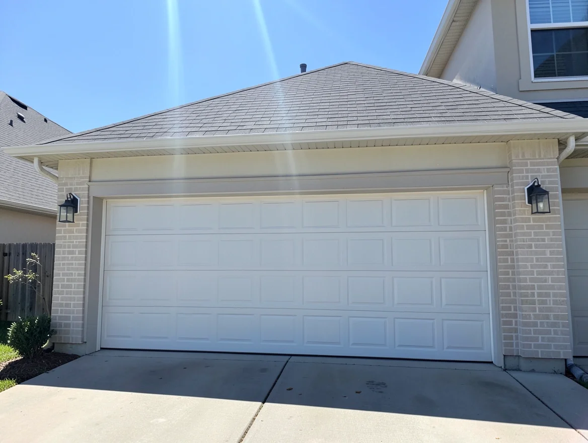 Exterior of a closed residential garage door on a hot sunny day