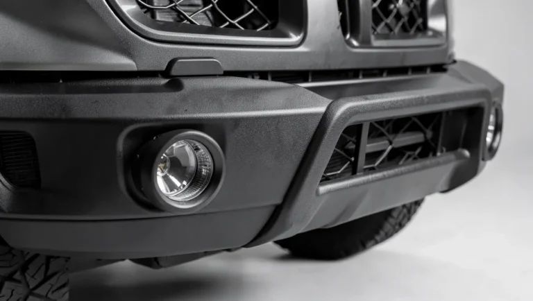 Custom off-road style front bumper with integrated fog lights and skid plate on a modified truck