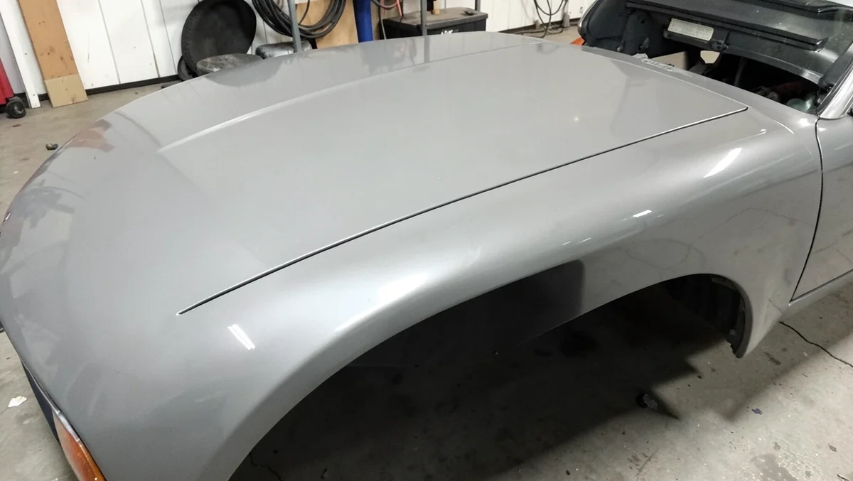 Close-up of a smooth glossy fiberglass car hood and fender panel