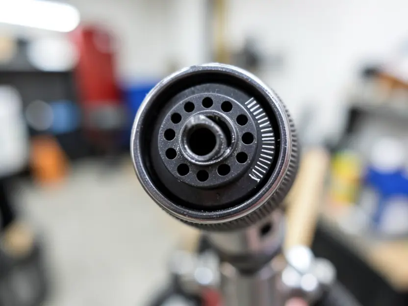 Close-up of an HVLP spray gun air cap and fluid tip nozzle