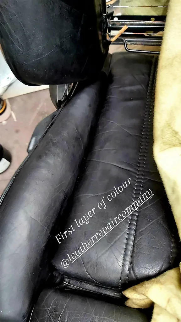 Close-up of leather car seat repair with cleaner, cloth, and a cracked seat section