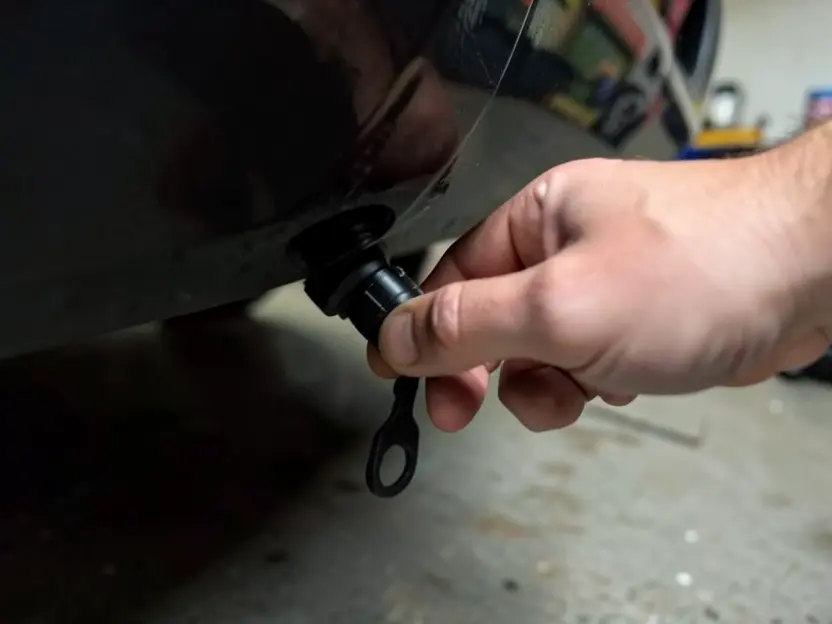 Attaching a small magnetic GPS tracker to the underside of a car being rented out