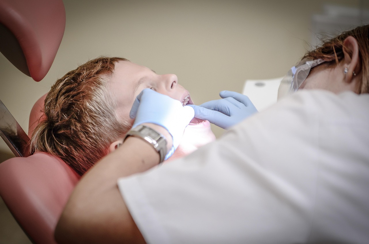 Dentist examining a patient's teeth during a routine dental checkup