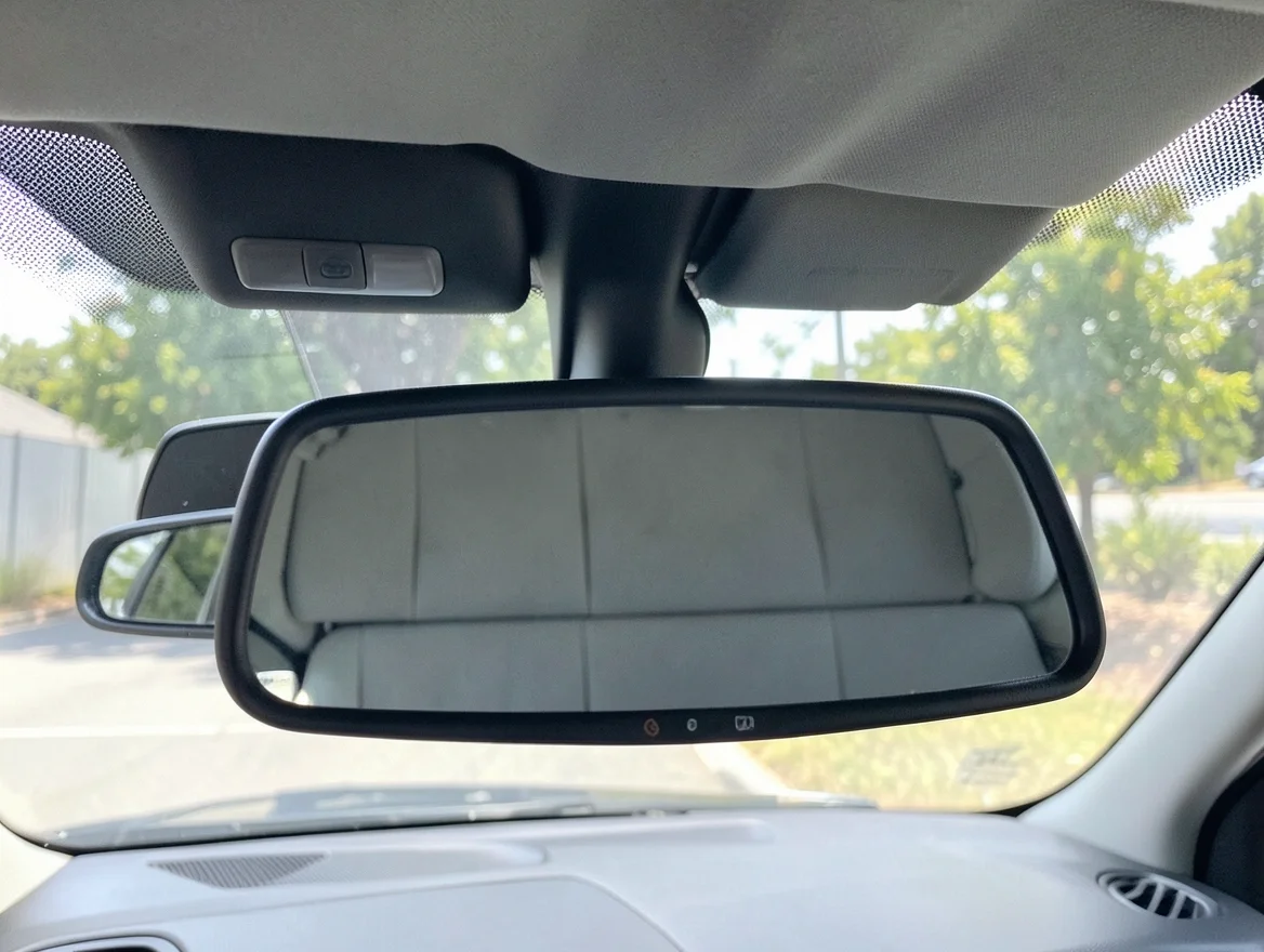 Driver view through the rearview mirror toward the back seat of a car