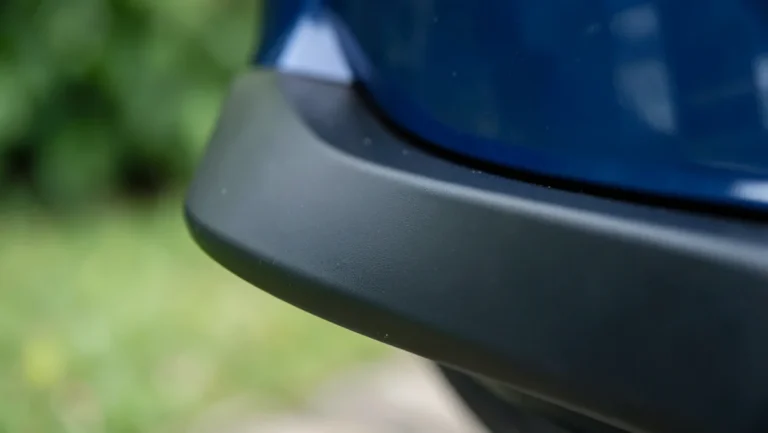 Close-up of a black universal lip spoiler edge mounted on a car trunk