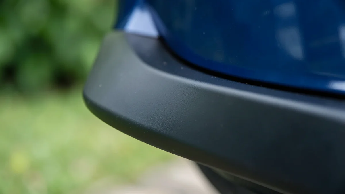 Close-up of a black universal lip spoiler edge mounted on a car trunk