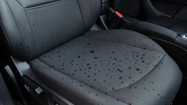 Black waterproof car seat cover beading water droplets on the surface