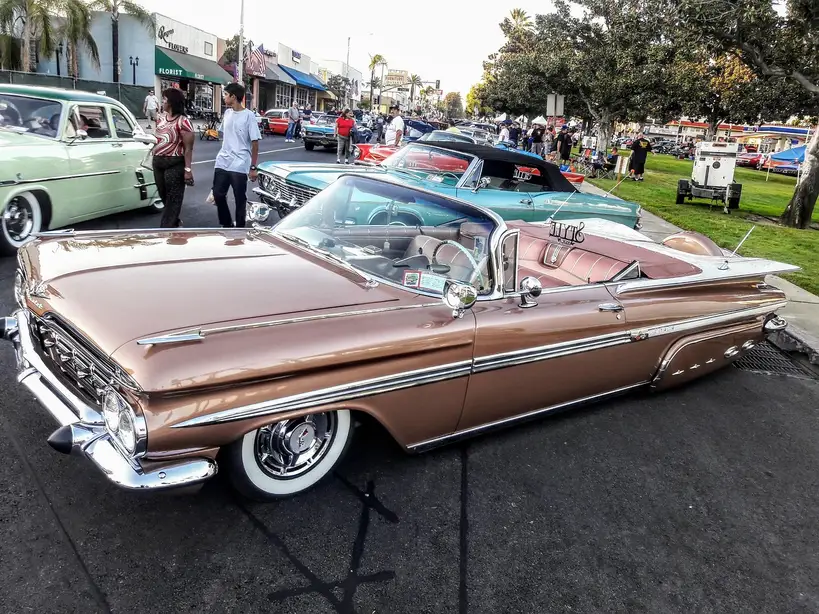 1971 Monte Carlo lowrider parked in daylight with chrome wheels and a lowered stance