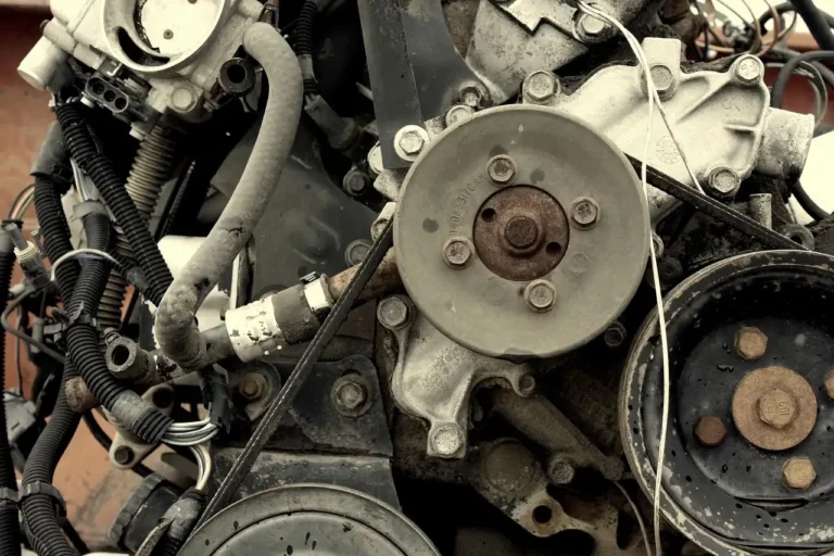 Mechanic inspecting the serpentine belt routing on a 2026 Ford Fusion with the hood open