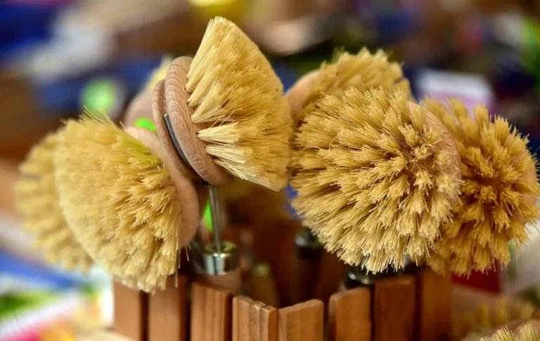 Wheel cleaning brushes beside a car wheel with deep barrel and tight spokes