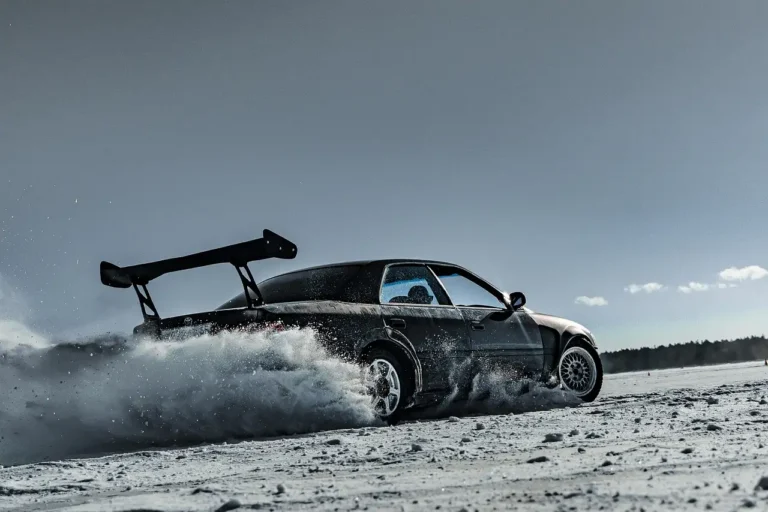 4th gen Camaro drift car on jack stands with exposed front suspension and brake clearance check