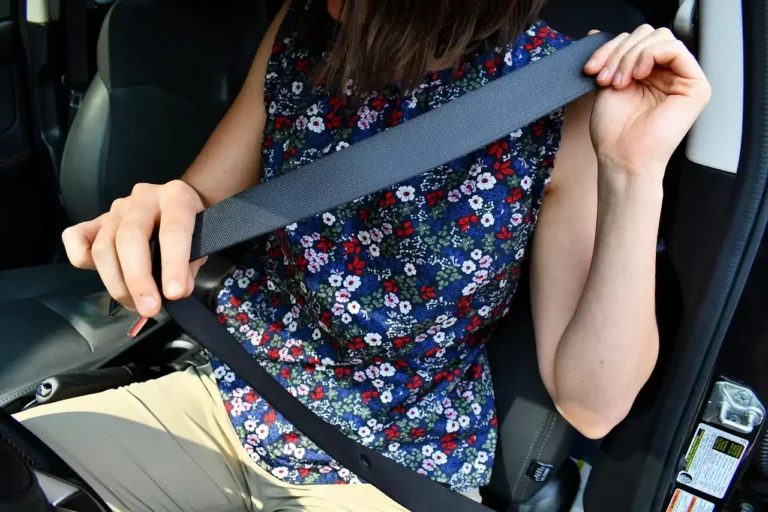 Family SUV interior with a salesperson explaining safety features to a parent and child