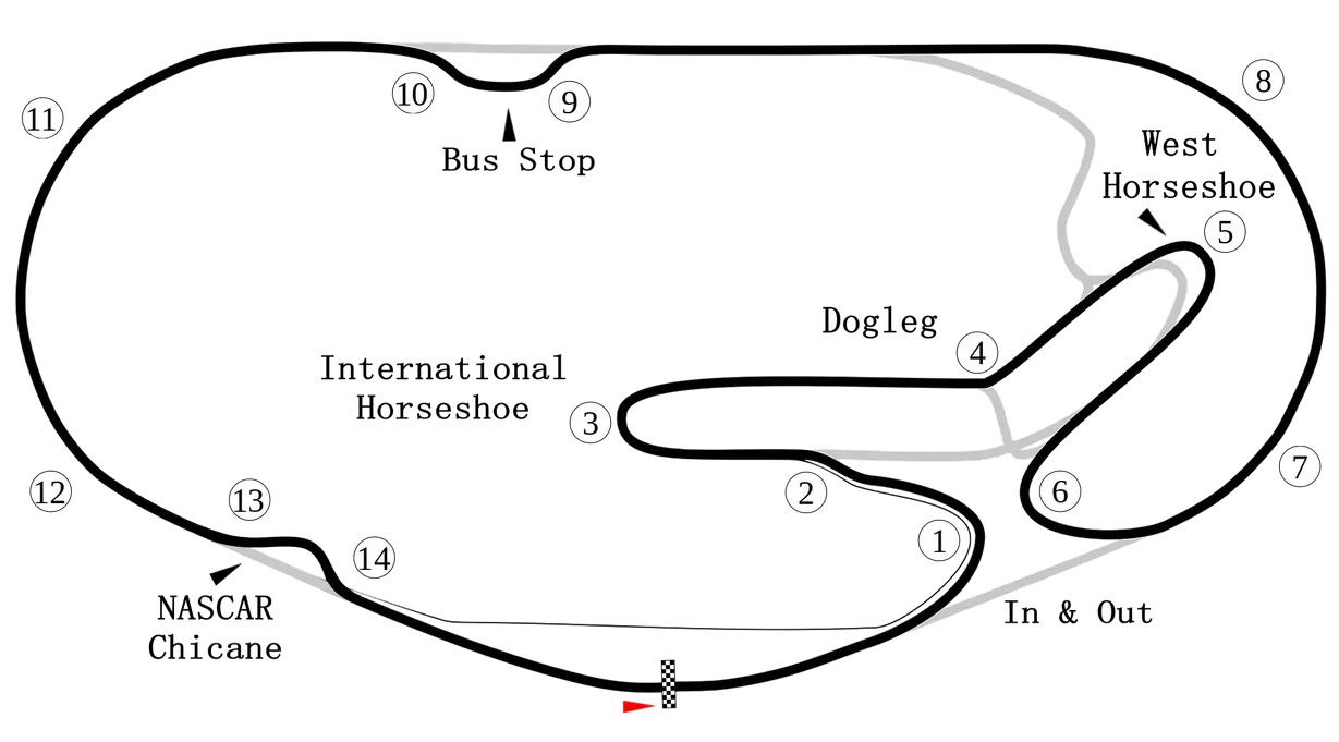 NASCAR stock car racing through a left-hand oval turn at a modern speedway