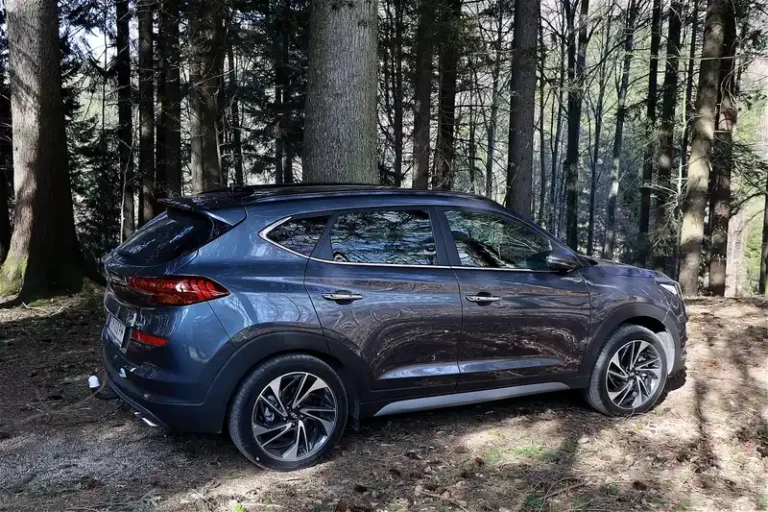 2026 all wheel drive hybrid sedan parked on a suburban street in warm natural light