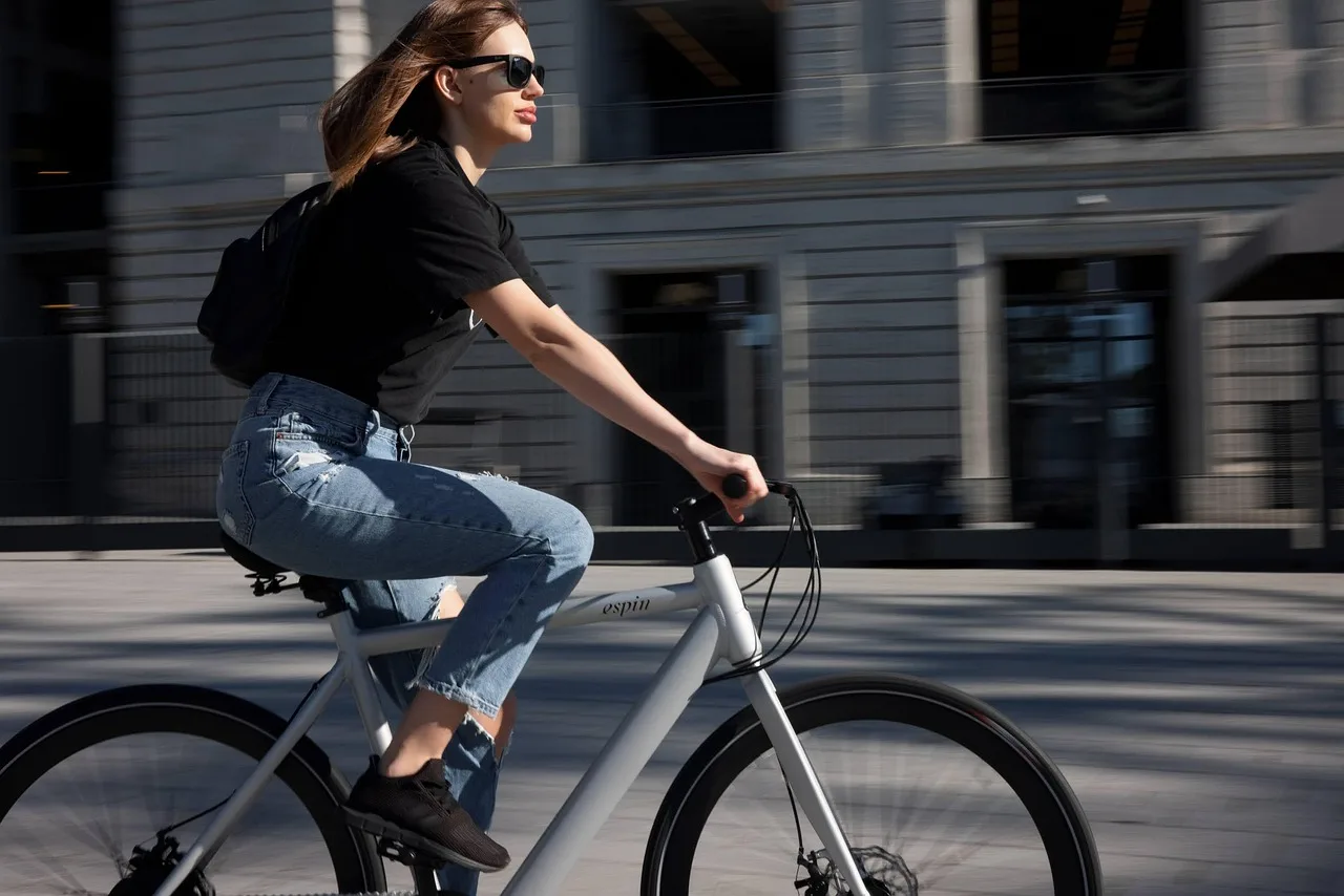 Alternative transportation to cars near a transit stop with a bicycle, bus, and rideshare pickup area.
