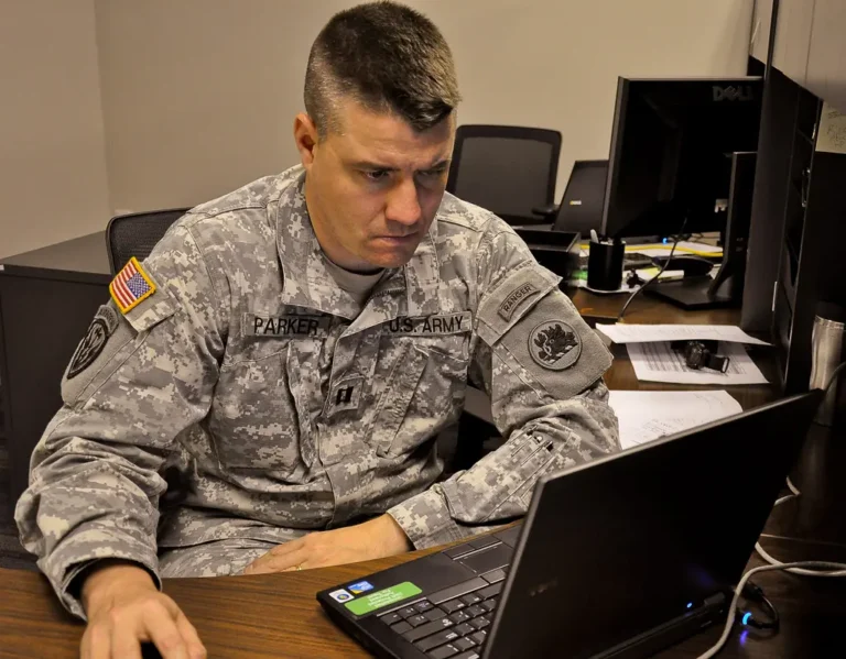 Radiology technologist monitors an auto-aligned CT workflow in a bright control room.