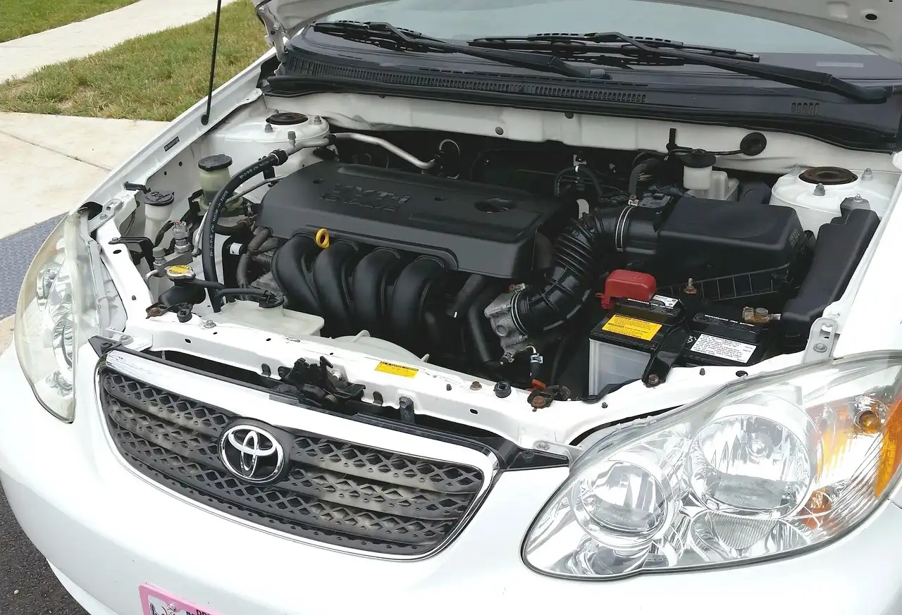 A mechanic talks with a customer beside a silver hatchback at Auto Stop Service Centre Warrington