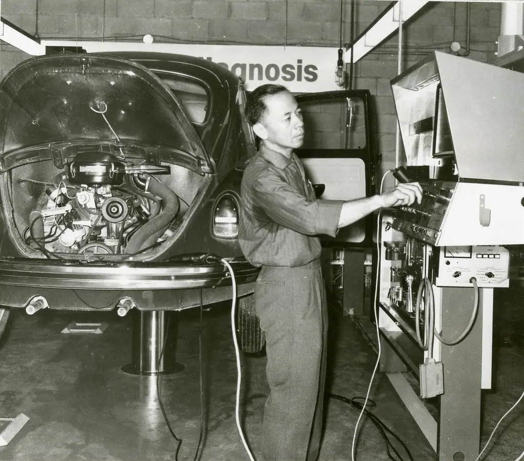 A technician checks a car with a handheld diagnostic scanner at Auto Stop Service Centre Warrington