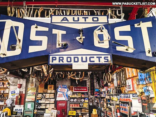 Close-up of the Automotive Parts and Accessories Association history with an old ledger and vintage auto parts