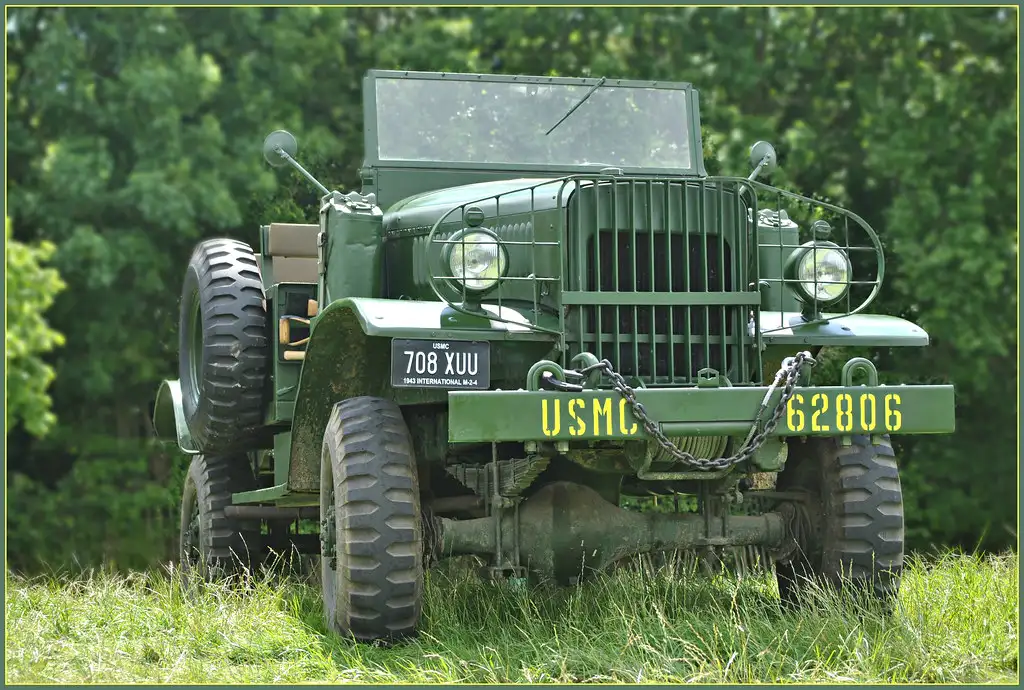 Hand moving a 4WD transfer-case lever from 2H to 4L inside a rugged cabin