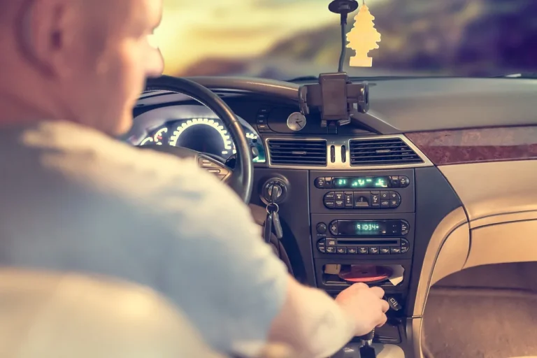 Three car air fresheners on a leather dashboard in natural light