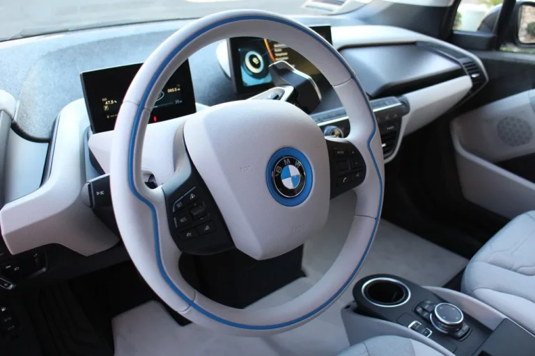 Car interior cleaning tools beside a dusty dashboard and stained fabric seat in natural light