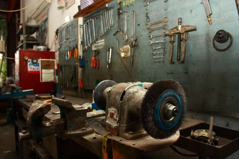 Beginner car maintenance kit laid out on a garage workbench beside a sedan