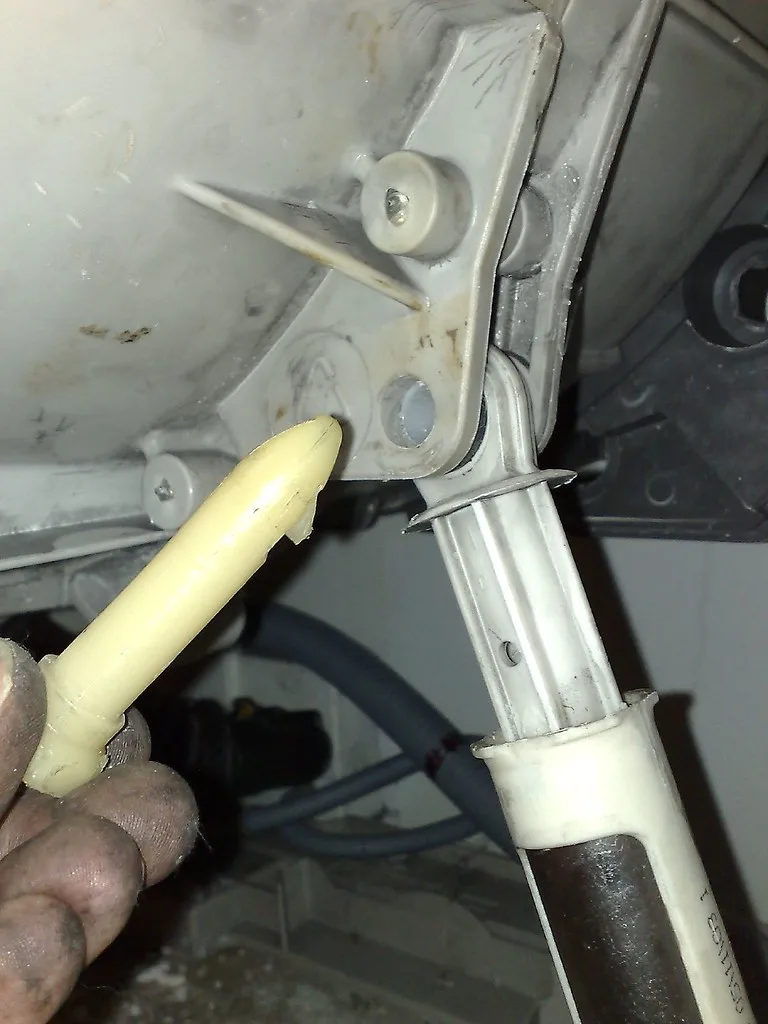 Hands checking a car tire with a digital pressure gauge in a driveway