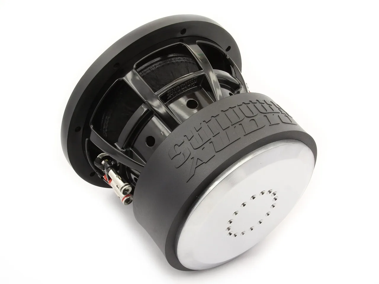 Under-seat car subwoofer beside a front seat in a small car with a tape measure