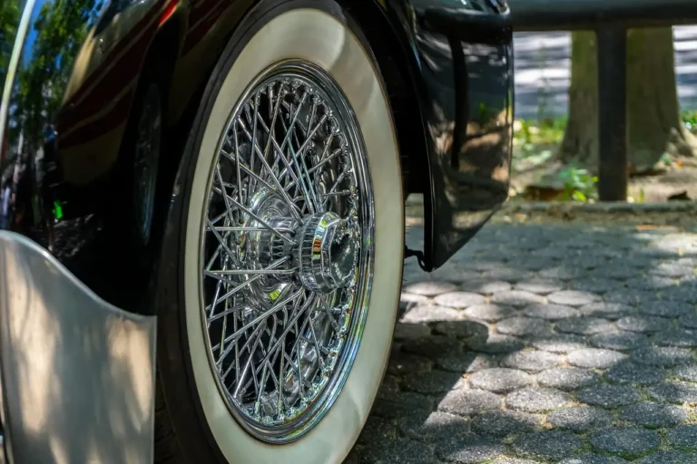 Three tire shine applicators beside a sedan tire in a driveway