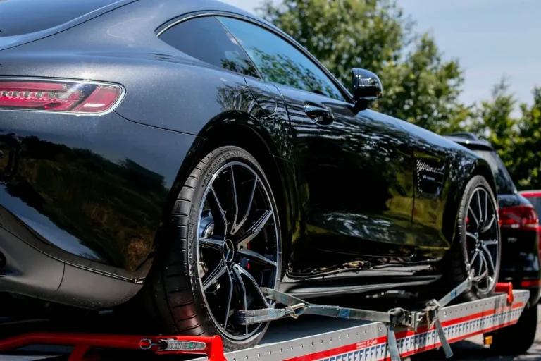 Midsize SUV hitched to a travel trailer at an RV campsite with a driver checking the setup