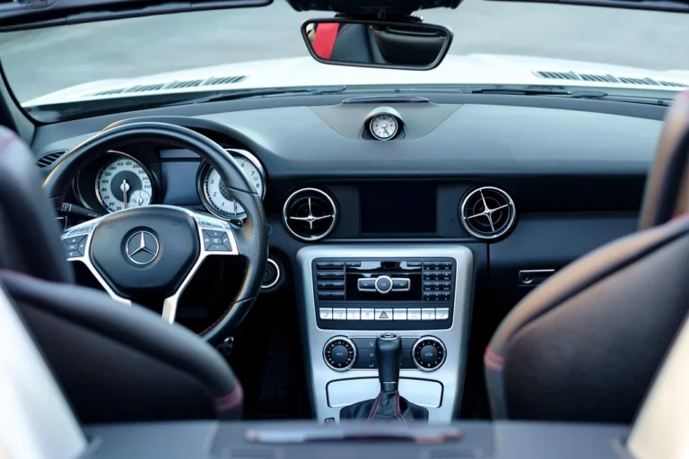 Three center console organizers in a modern car interior on the front seats in natural daylight