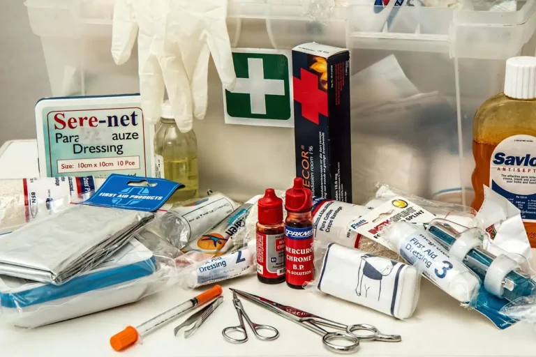 Three first aid kits with medical supplies arranged inside a car in natural light