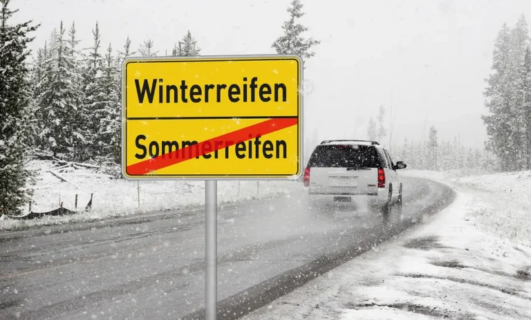 Compact car on a snowy suburban street showing winter tires and icy road conditions