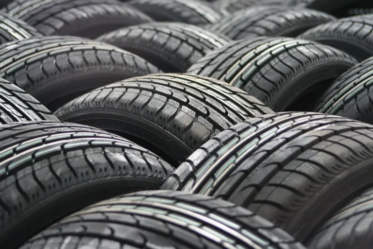 Passenger car with modern all-season tires parked on a wet road in natural light